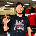 Carolina Hurricanes 2026 Stanley Cup Champions trophy alongside city skyline shirt